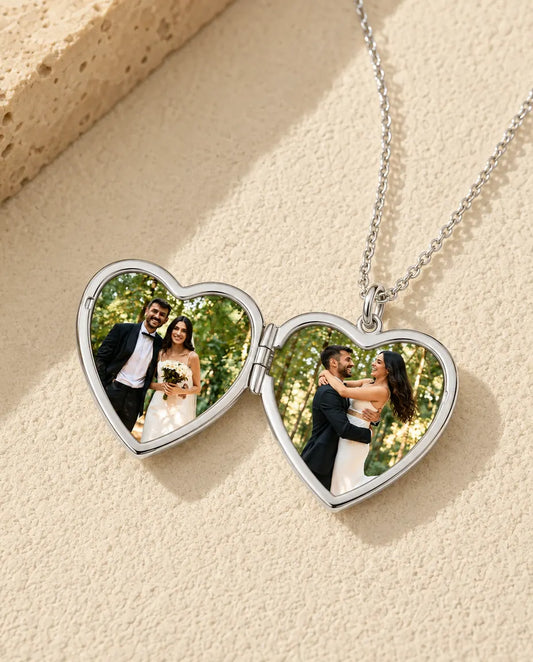 Heart photo locket necklace opened to show two wedding photos inside