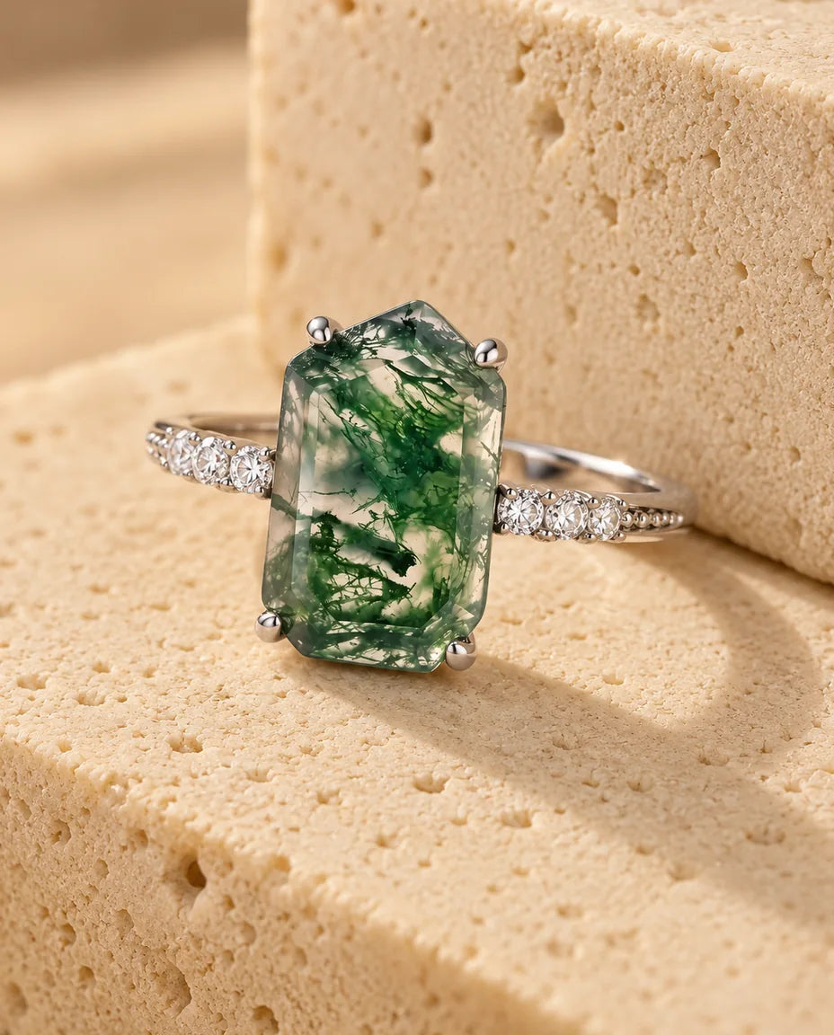 Emerald-Cut Moss Agate Adjustable Ring - displayed on a travertine block