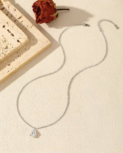 1 ct Pear Moissanite Necklace in 925 Sterling Silver - laid flat with the full chain, clasp and extender