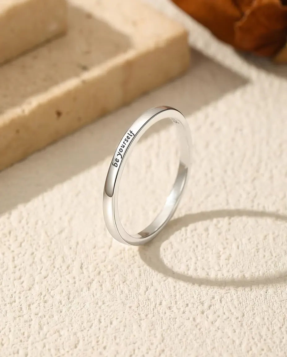 Be Yourself Ring in 925 Sterling Silver - standing upright on a cream textured surface