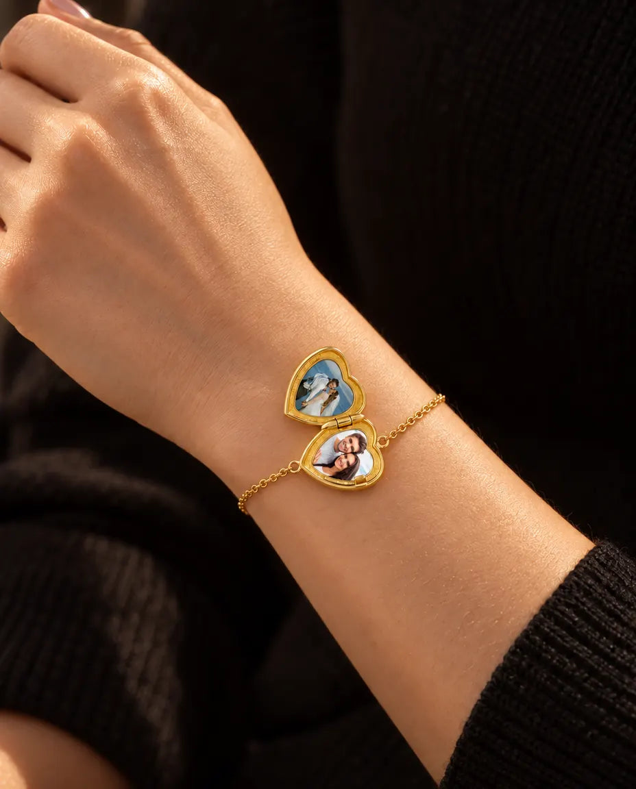 Woman wearing the heart locket bracelet open, showing two photos