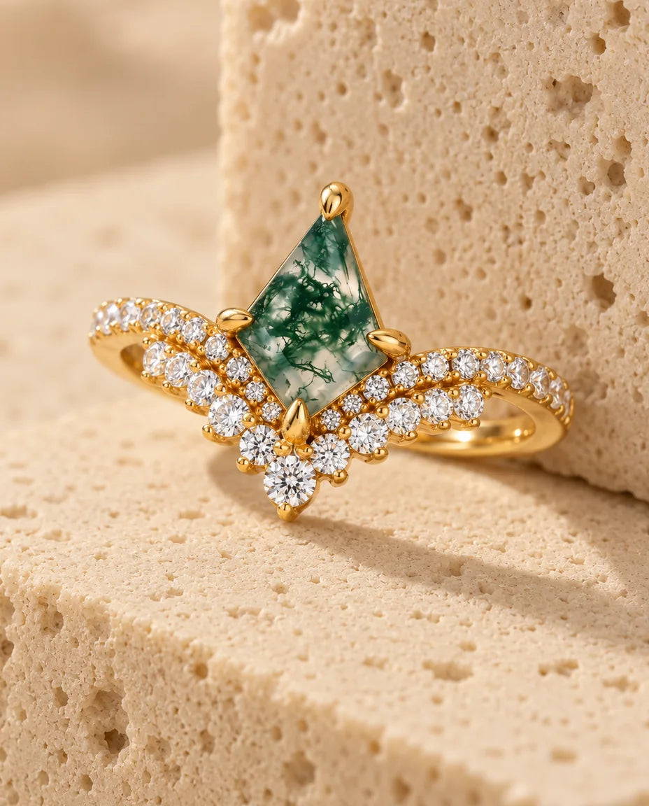 Kite-Shaped Moss Agate Ring - displayed on a travertine block