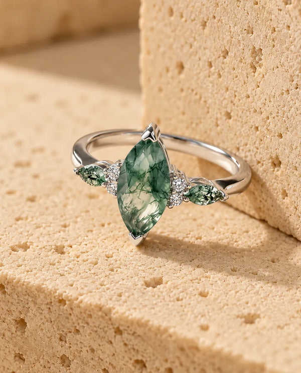 Moss Agate Ring - displayed on a travertine block