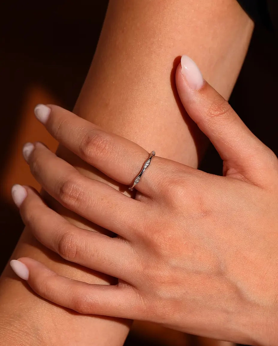 Moissanite Wave Ring in 925 Sterling Silver - worn on a model’s finger, close-up