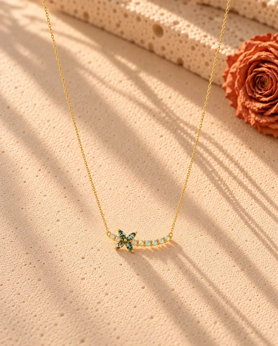 Moss Agate Flower Necklace in Gold Plated 925 Sterling Silver - the whole necklace laid out in a long V on a cream textured surface