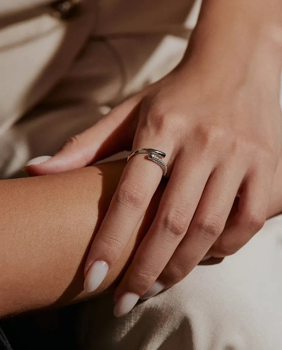 Pave Moissanite Bypass Ring in 925 Sterling Silver - worn on a model’s finger, close-up