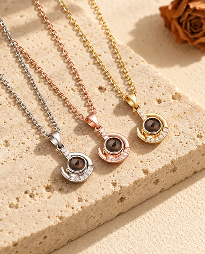 Silver tone, rose gold tone and gold tone crescent pendants in a row