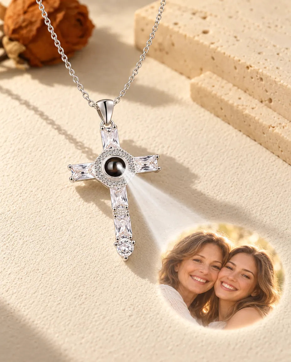 Silver tone cross necklace projecting a mother and daughter photo onto plaster