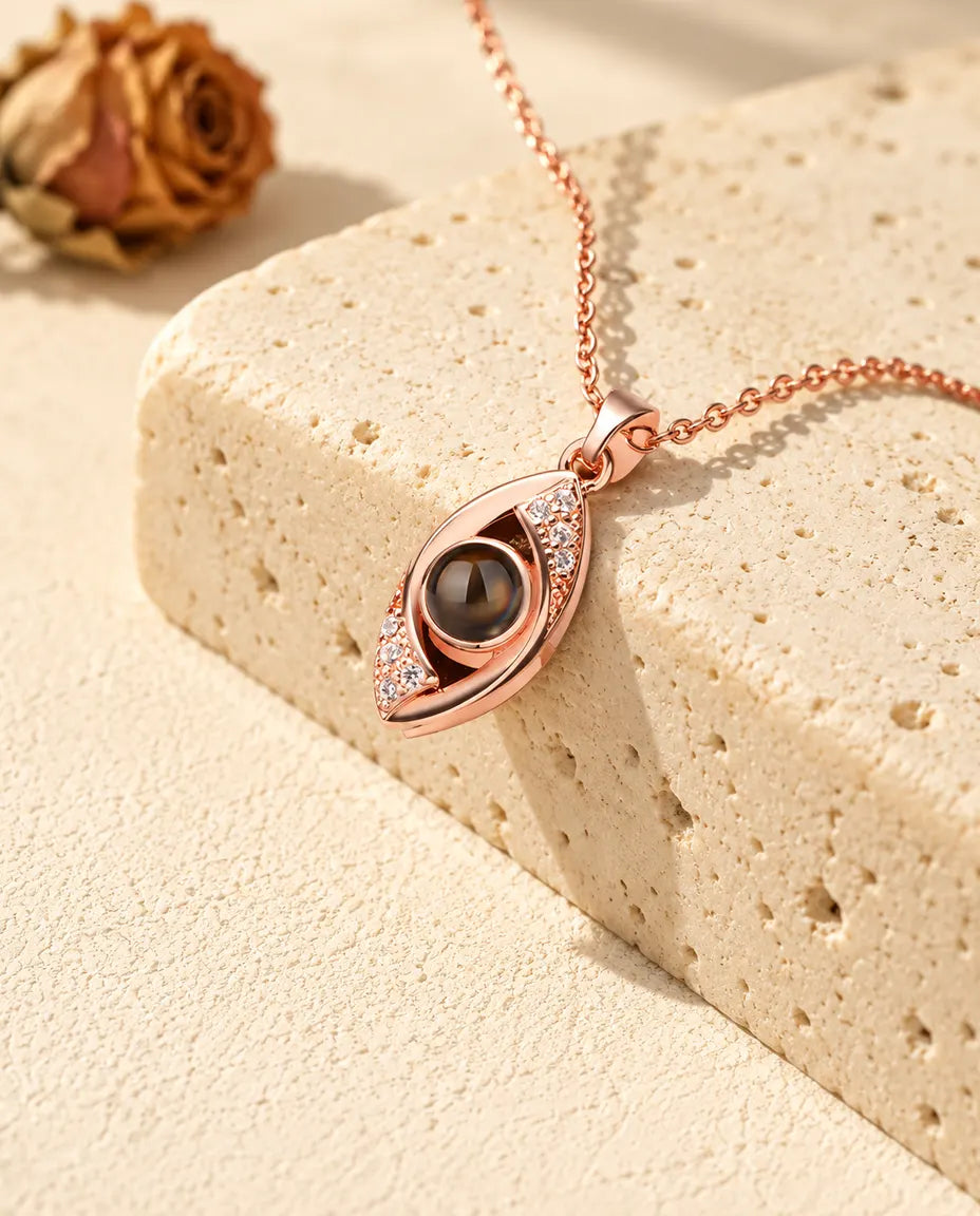 Rose gold tone evil eye projection necklace with cubic zirconia lids