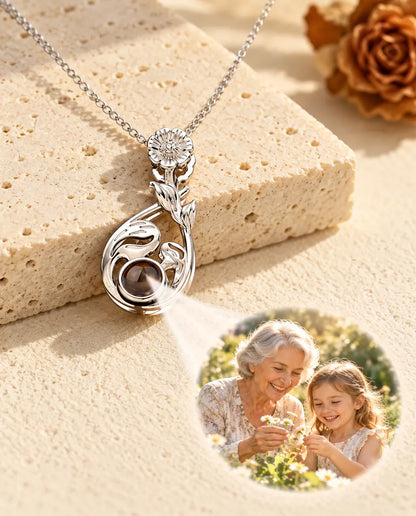 Silver tone flower teardrop necklace projecting a grandmother and granddaughter photo onto plaster
