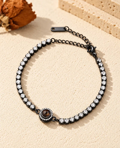 Black tennis bracelet with clear cubic zirconia and a halo projection charm