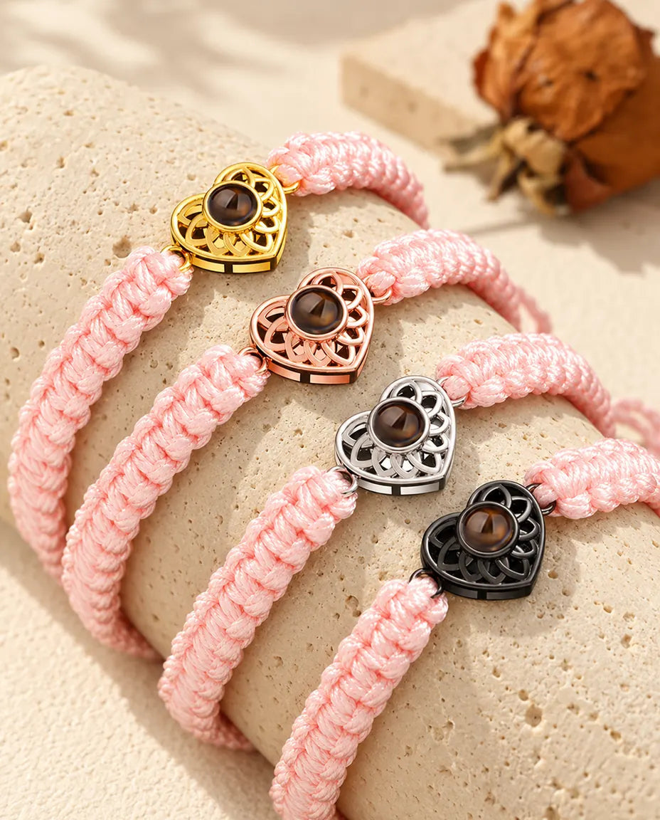 Pink braided cord projection bracelets with gold tone, rose gold tone, silver tone and black heart charms