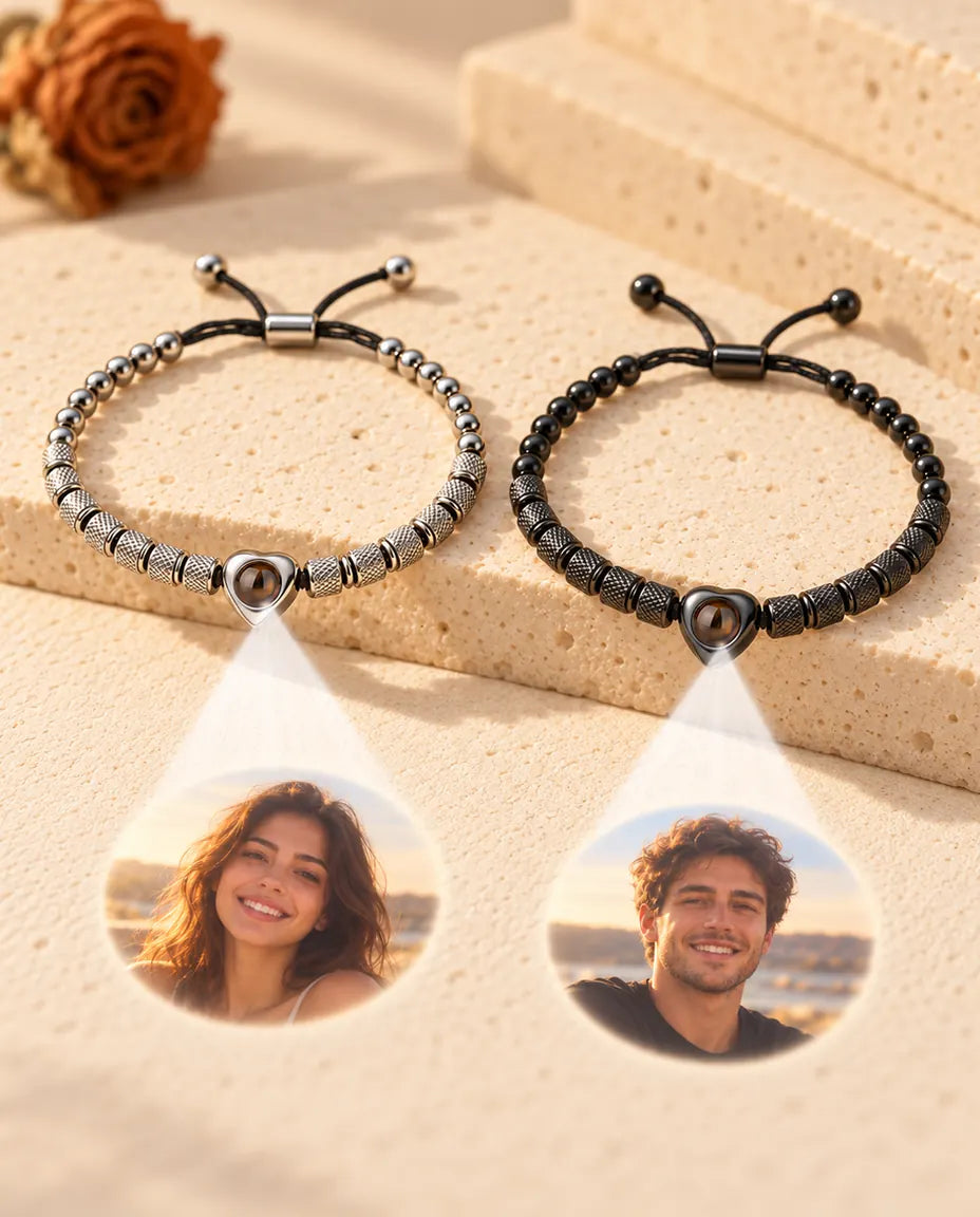 Two heart bead bracelets project two round photos, one of a smiling woman and one of a smiling man