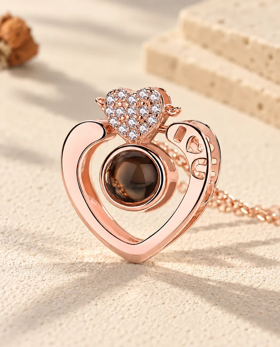 Close-up of the rose gold tone open heart with I heart U cut-outs and a pave heart