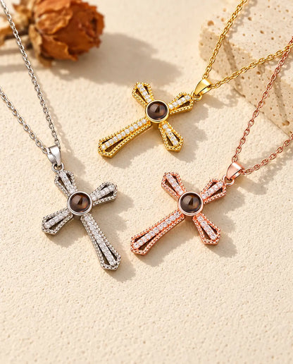 Silver tone, gold tone and rose gold tone crosses with brown projection stones arranged by a travertine slab