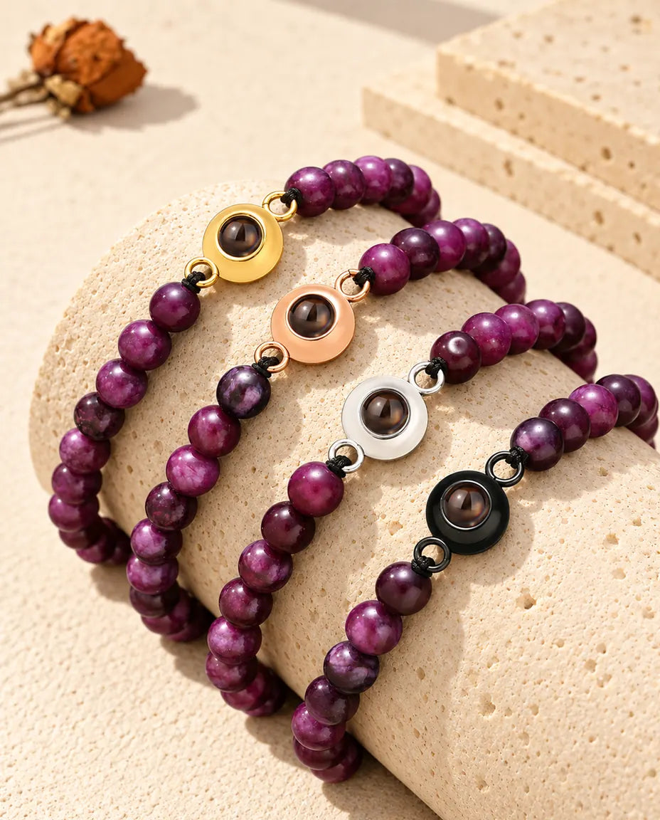 Purple bead projection bracelets with gold tone, rose gold tone, silver tone and black charms