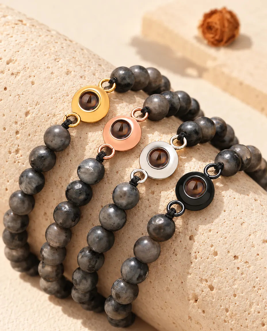 Grey speckled bead projection bracelets with gold tone, rose gold tone, silver tone and black charms