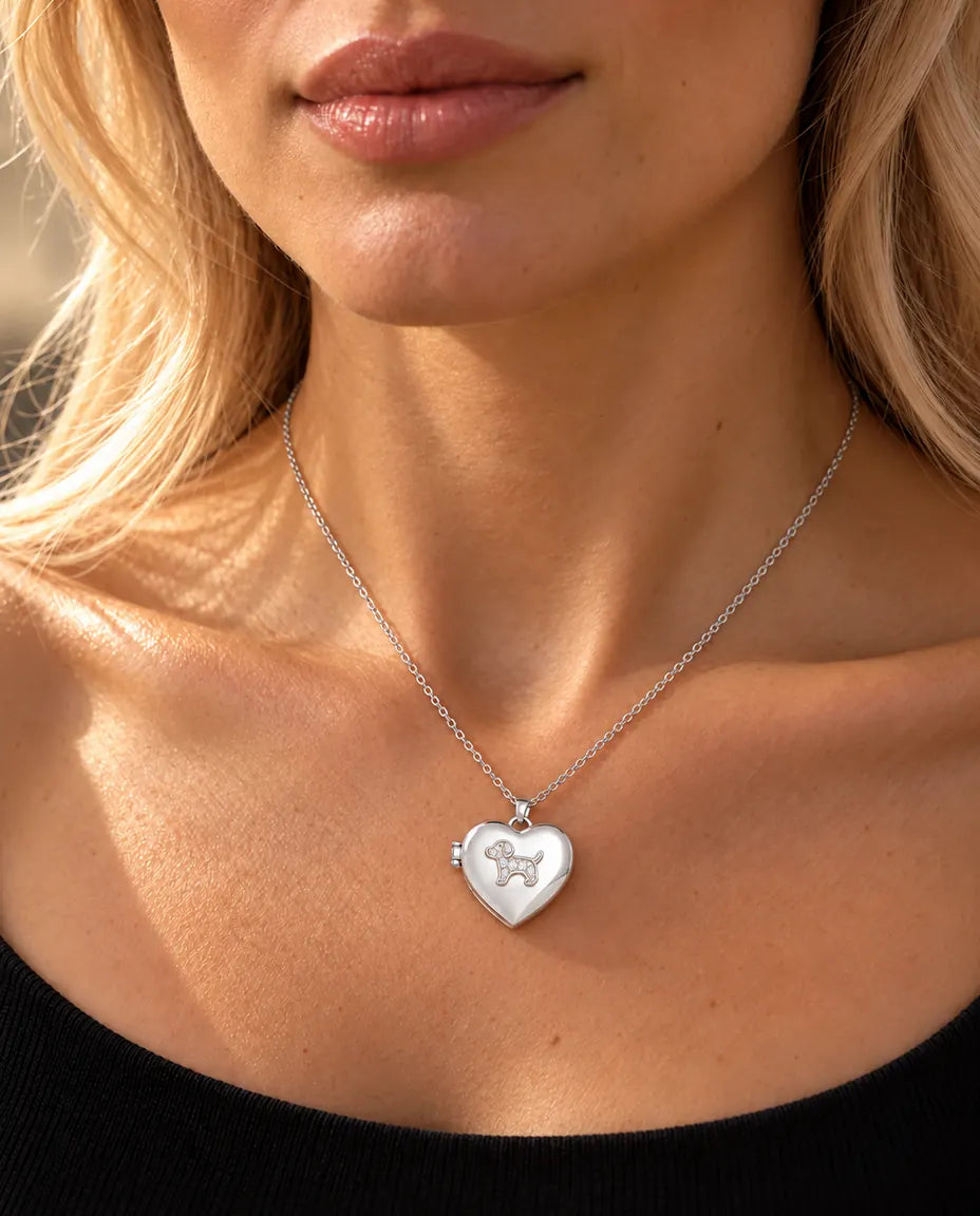 Woman in a black knit top wearing the silver tone puppy heart photo locket necklace
