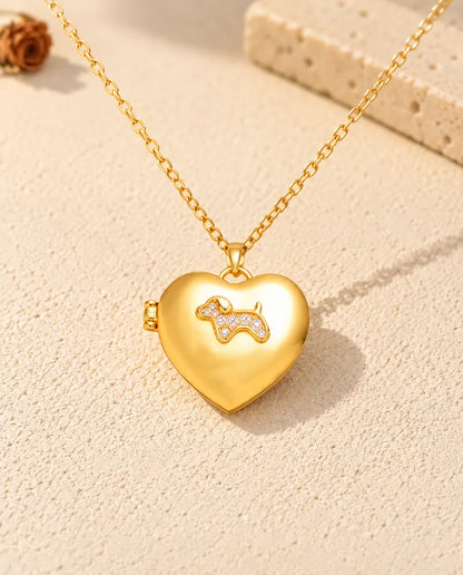 Front view of the gold tone puppy heart photo locket showing the lid design and side hinge