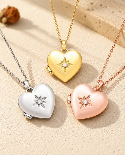 Three colours of the satin flower heart photo locket necklace arranged on plaster