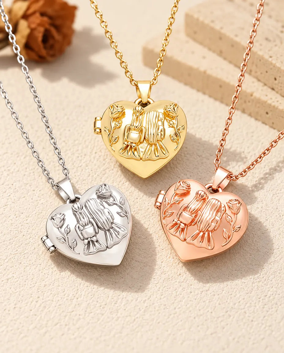Three colours of the sisters heart photo locket necklace arranged on plaster