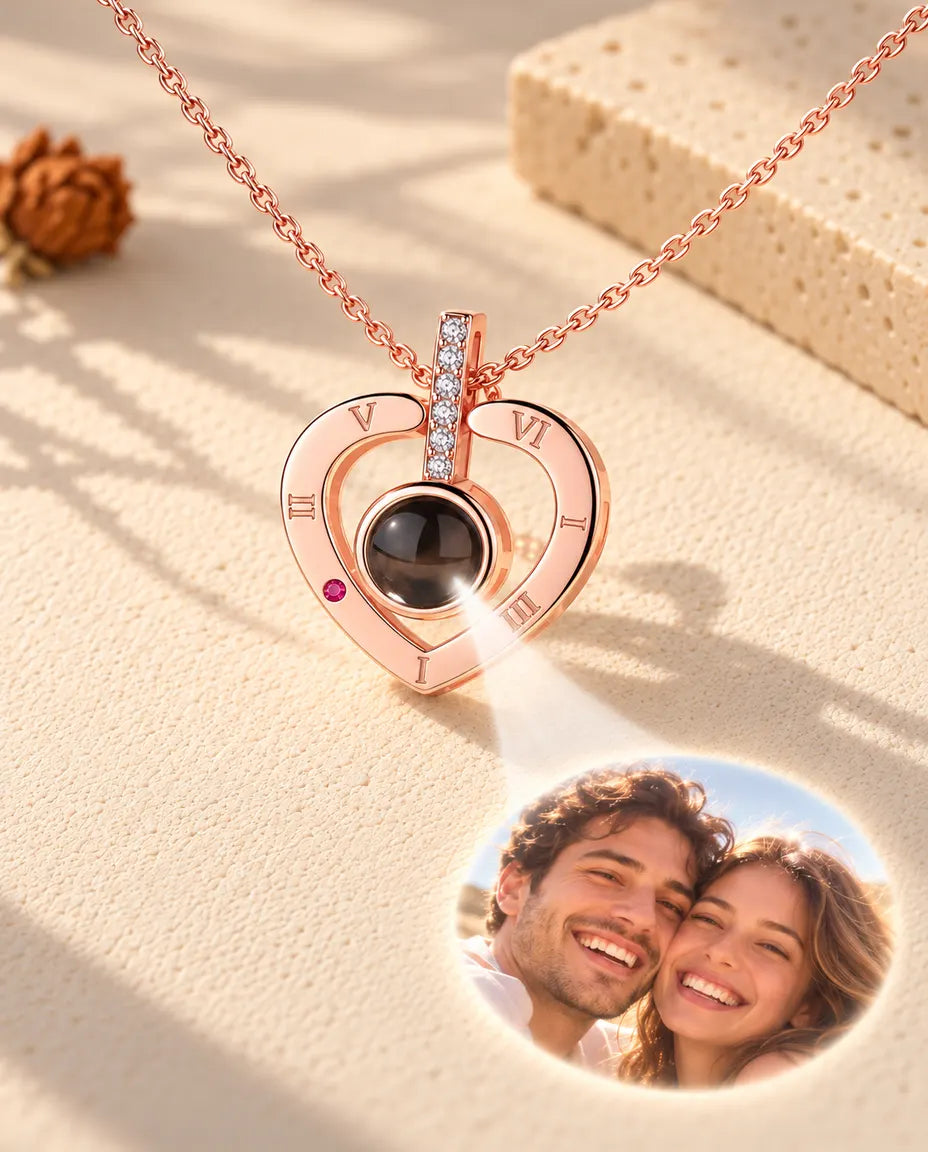 Rose gold tone Roman numeral heart necklace projecting a couple photo onto cream plaster
