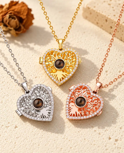 Tree of life heart projection lockets in silver tone, gold tone and rose gold tone on cream plaster