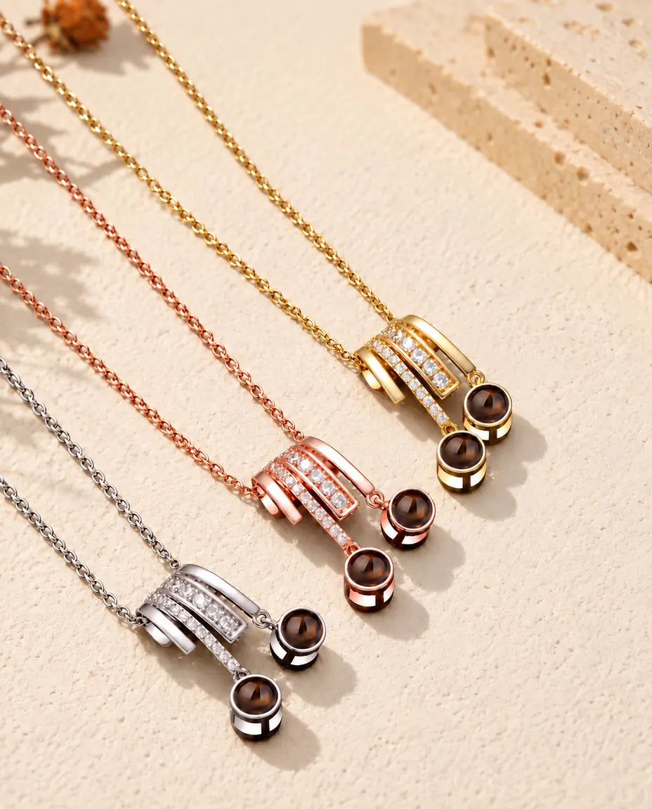 Three colours of the pave slide projection necklace arranged on cream plaster